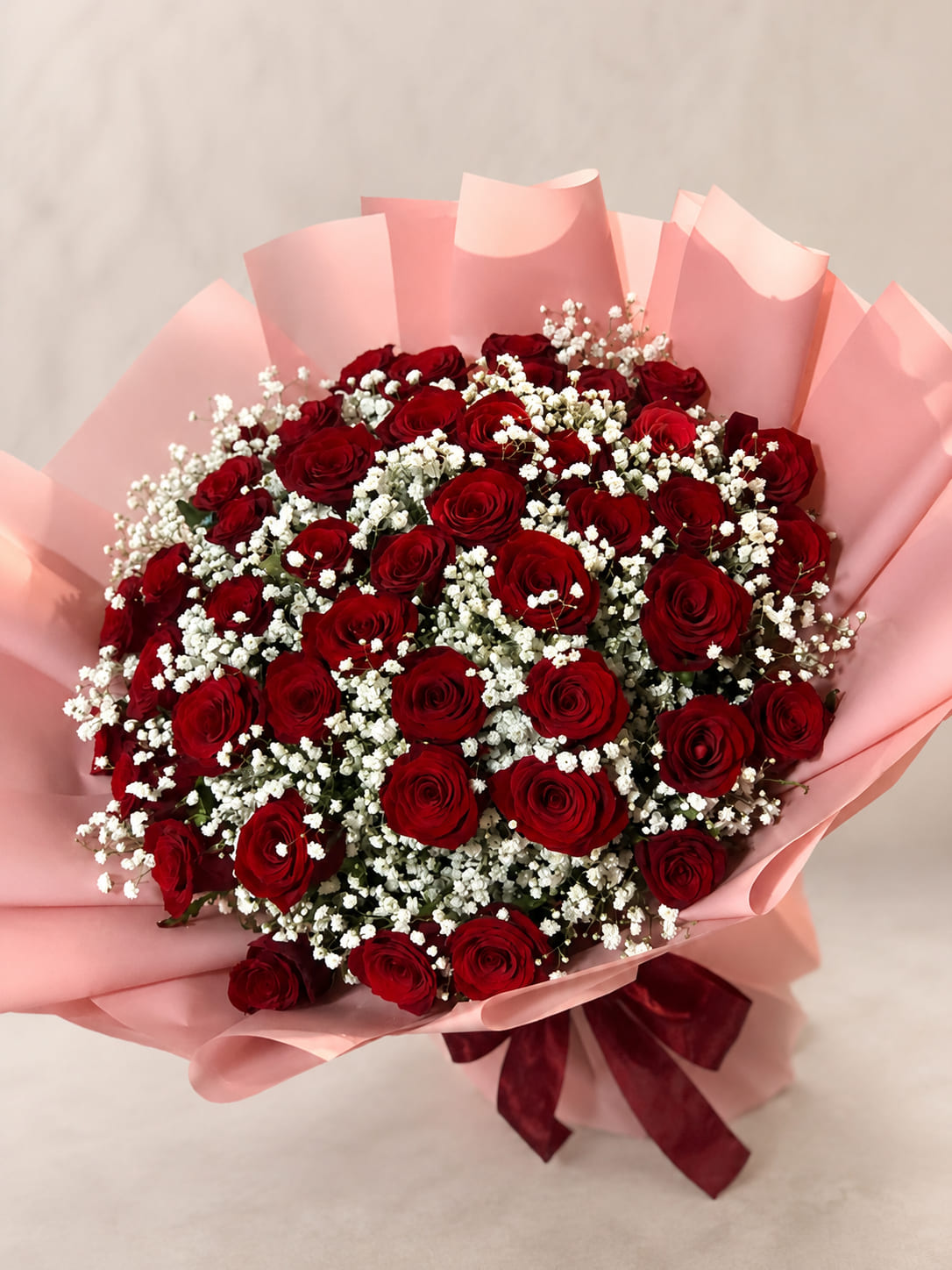 Scarlet Blush red rose bouquet with pink wrapping in Rabat
